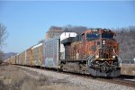 Eastbound vehicle train trails a filthy GEVO